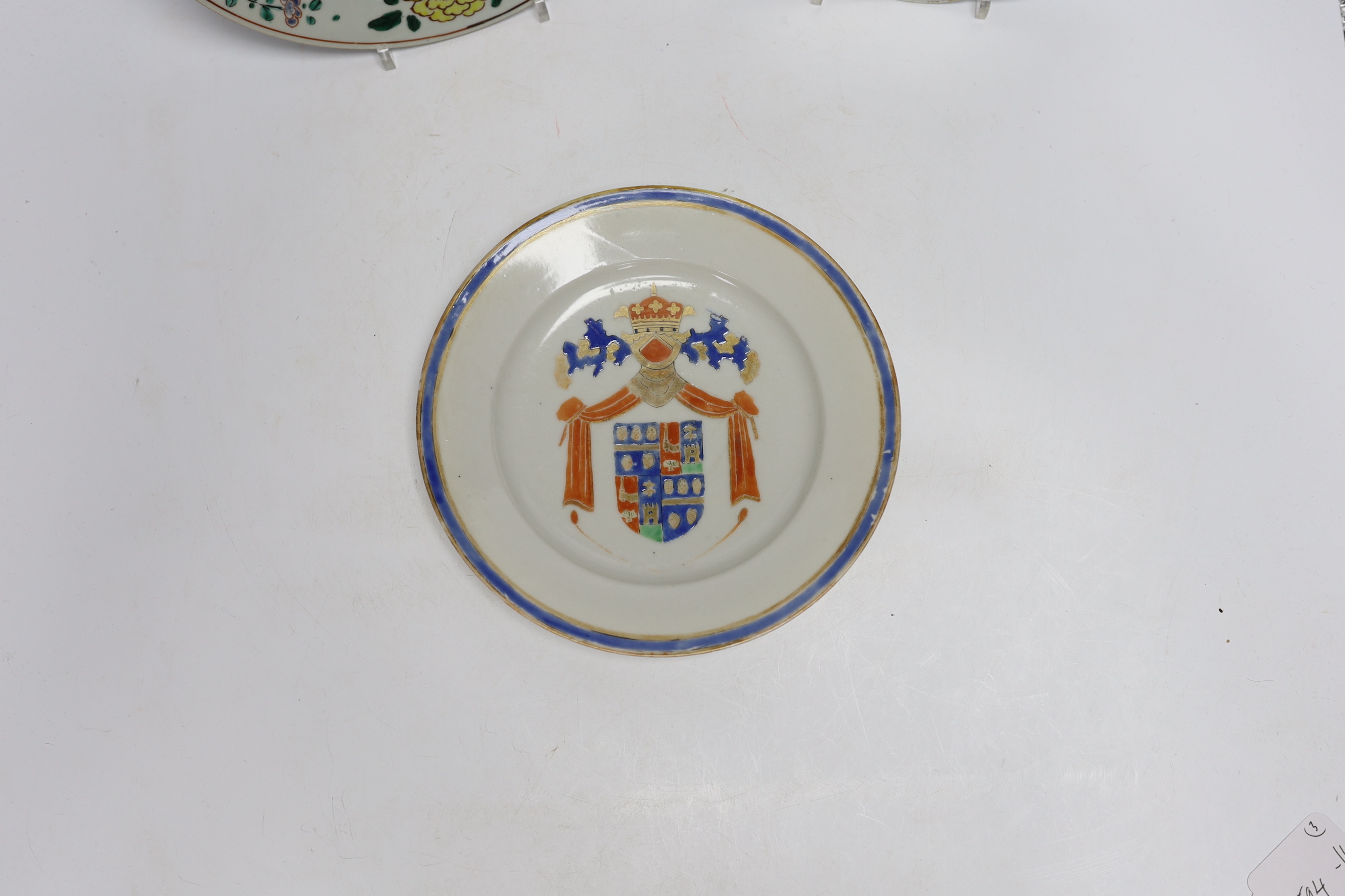 A Chinese famille rose plate together with two armorial or crested dishes, 23cm diameter